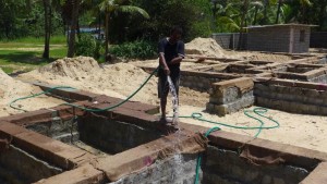 Neighbour helps to keep the concrete wet