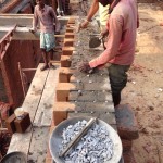Pebbles used as spacers between the mud blocks