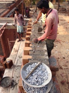 Pebbles used as spacers between the mud blocks