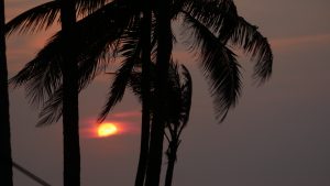 Watching the sun slide into the sea